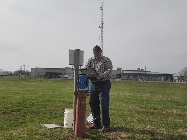 KGS geologist Glynn Beck downloading transducer data from the KGON-3 well at the KGS office in western Kentucky .
 