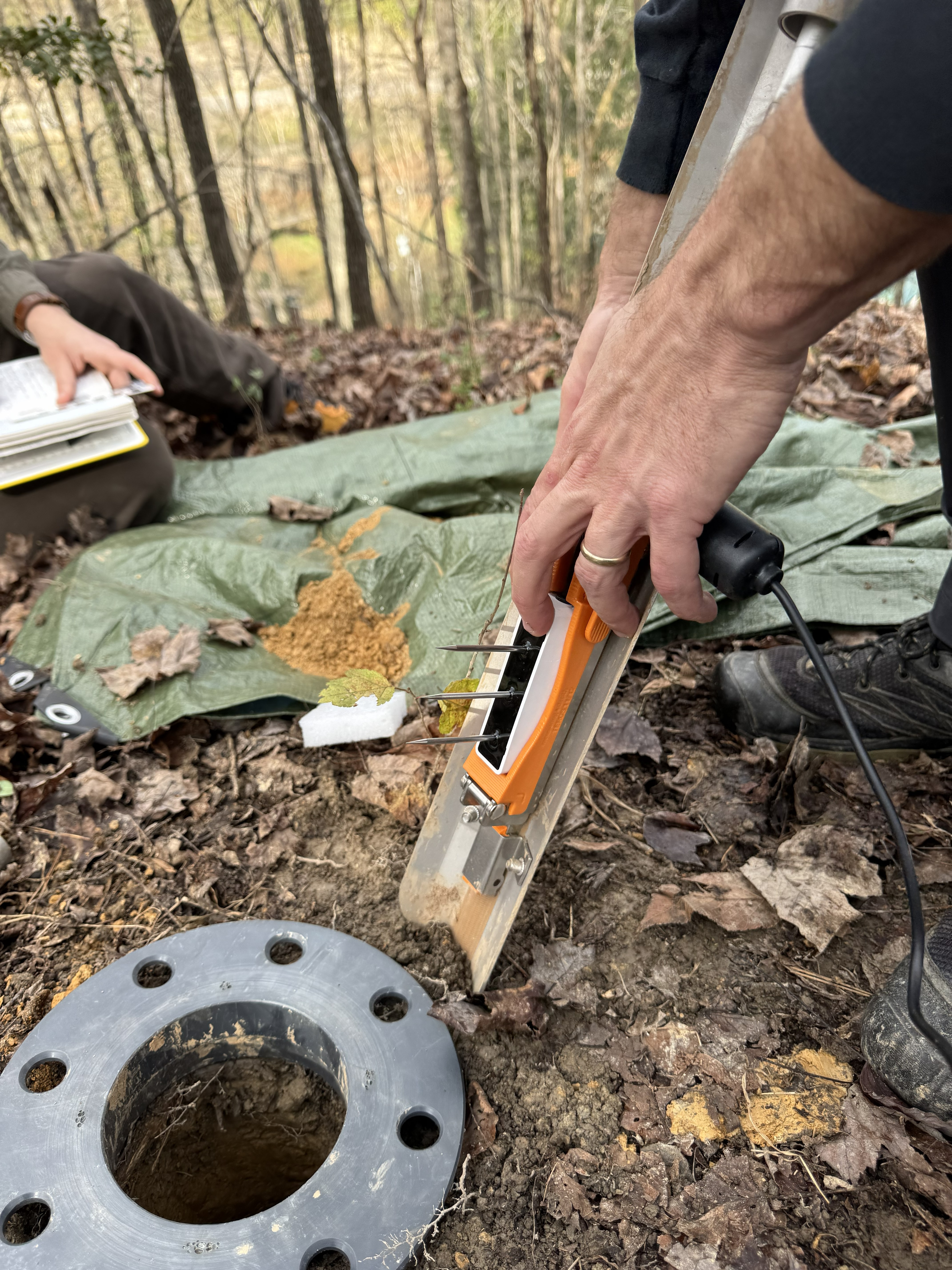 Placing the sensor in hand-augered borehole. Photo by Matt Crawford.