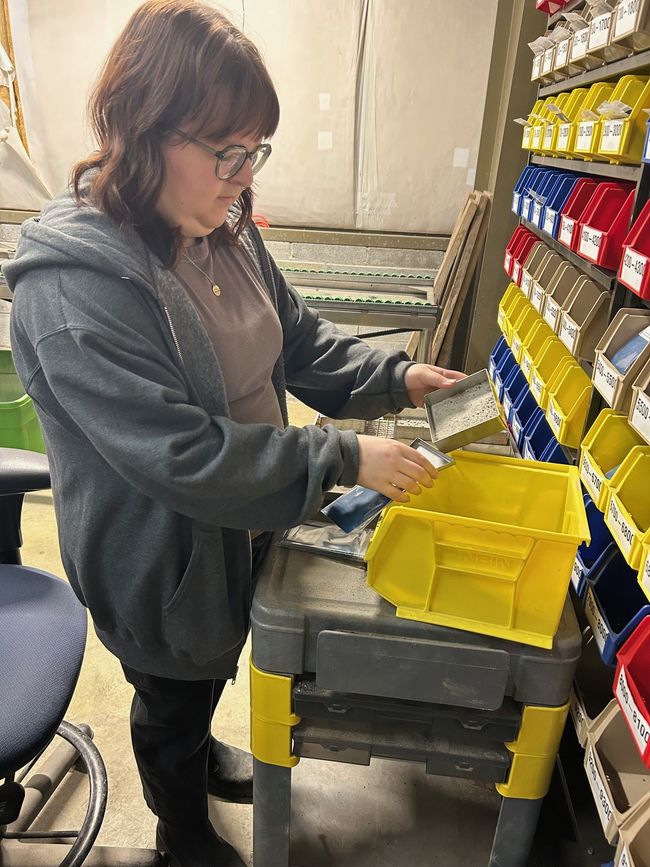 Archive tech Rachel Browning labels and bags clean well samples.